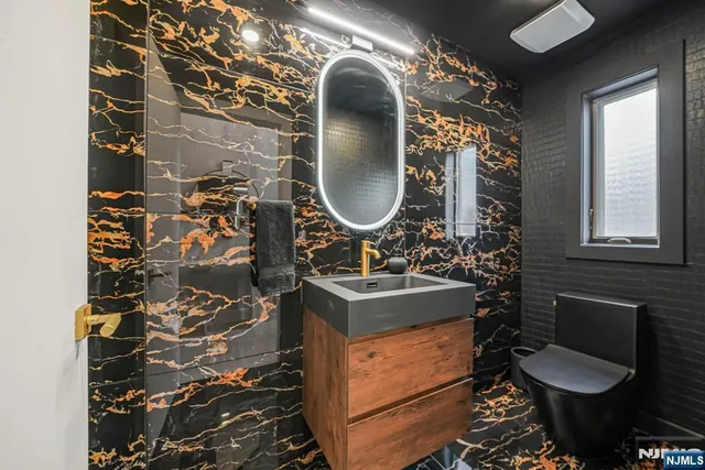 a bathroom with a toilet sink and mirror