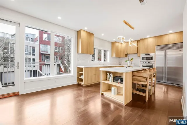 a kitchen with stainless steel appliances a stove top oven and a refrigerator