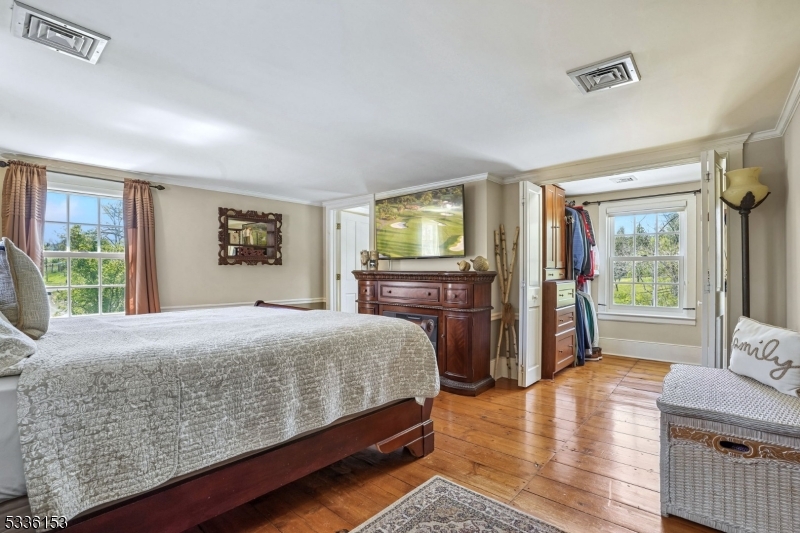 70 Pleasant Run Road Flemington, NJ 08822 - Photo 18 of 50 a bedroom with a bed dresser and a flat tv screen