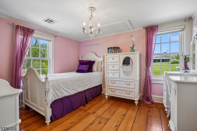 70 Pleasant Run Road Flemington, NJ 08822 - Photo 21 of 50 a bedroom with a bed and a chandelier
