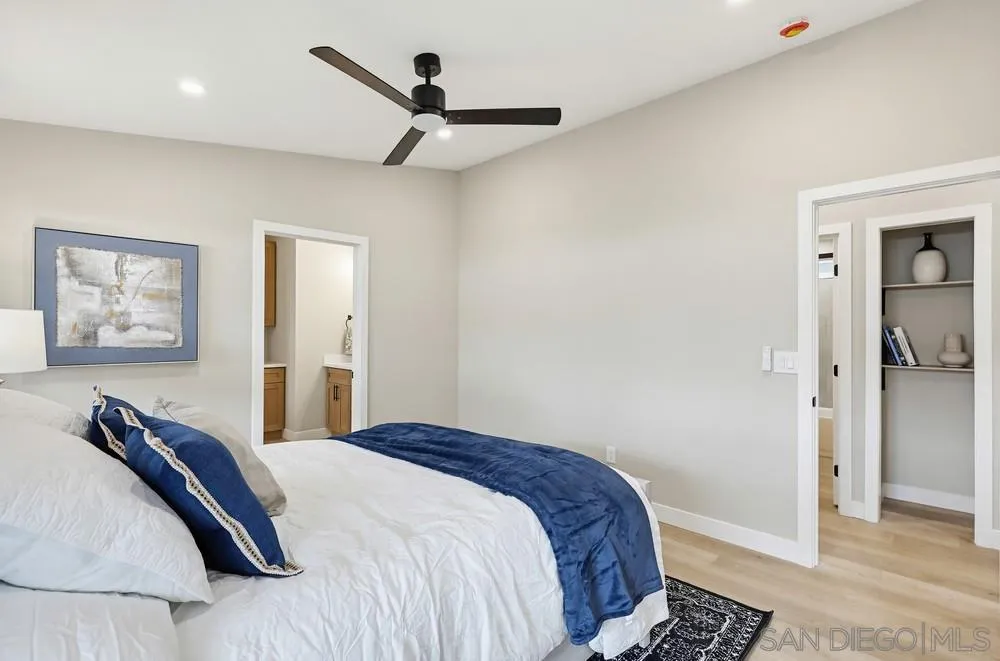 11949 Riverside Drive, Unit 23 Lakeside, CA 92040 - Photo 16 of 27 a bedroom with a large bed and a chandelier