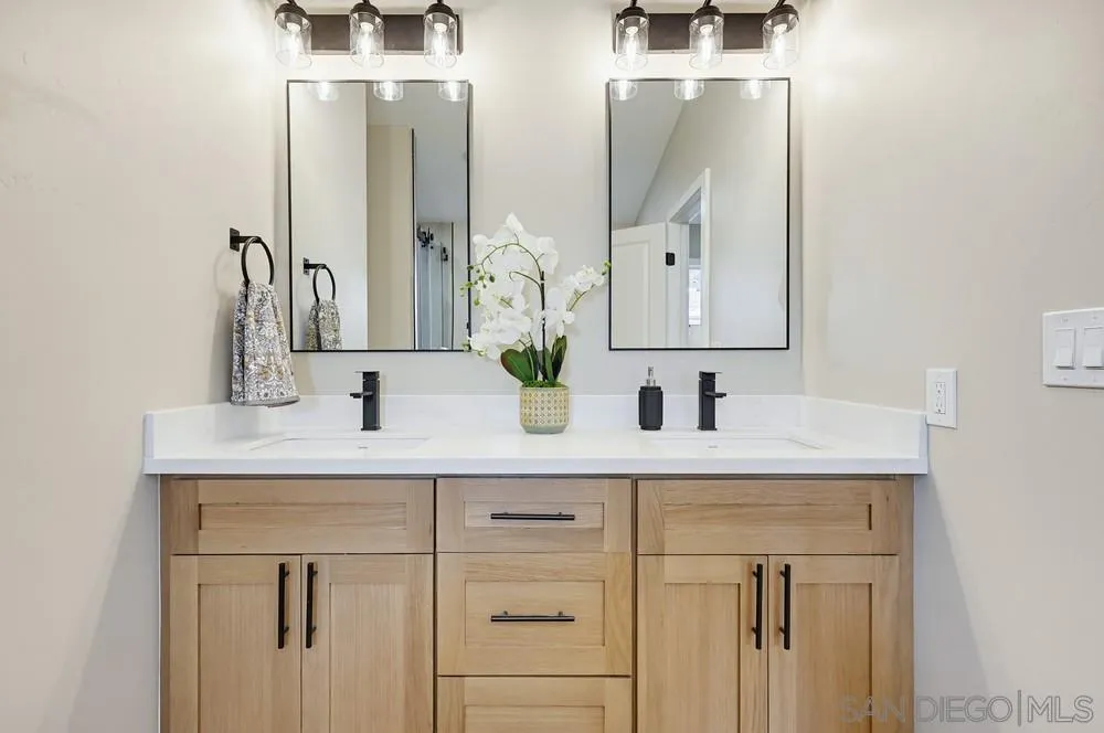 11949 Riverside Drive, Unit 23 Lakeside, CA 92040 - Photo 18 of 27 a bathroom with double vanity sink and two mirror