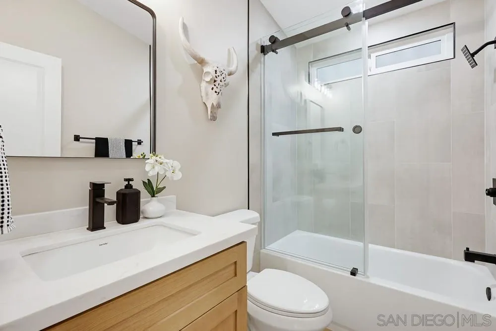 11949 Riverside Drive, Unit 23 Lakeside, CA 92040 - Photo 23 of 27 a bathroom with a bathtub shower sink vanity and toilet