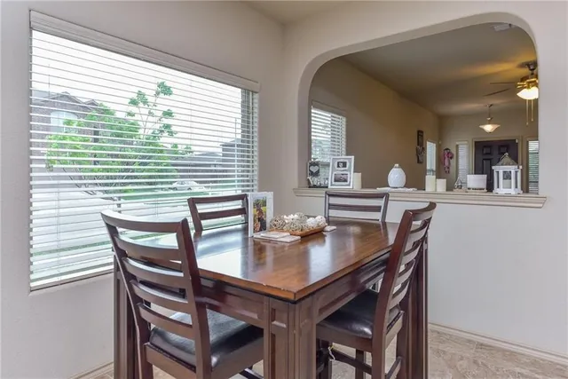 a view of a dining room with furniture and window