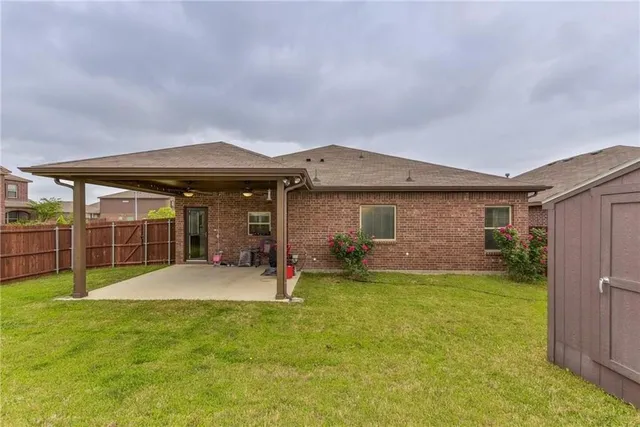 a view of a house with a yard and sitting area