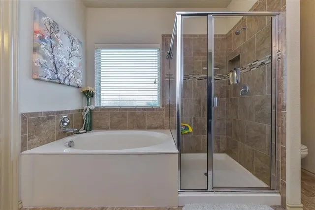 a white bath tub sitting next to a shower