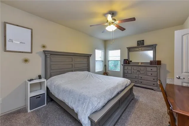 a bed room with a bed and a chandelier
