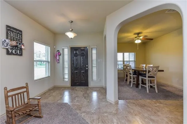 a view of a livingroom with furniture and windows