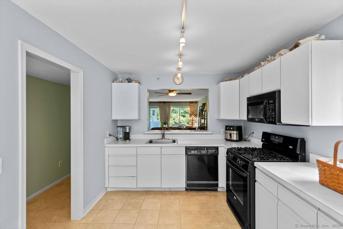 2 Mansfield Grove Road, Unit 262 East Haven, CT 06512 - Photo 12 of 40 The large wall window allows for easy passing through plates of food and to look out through the sliding glass doors to watch the sun set while doing dishes!