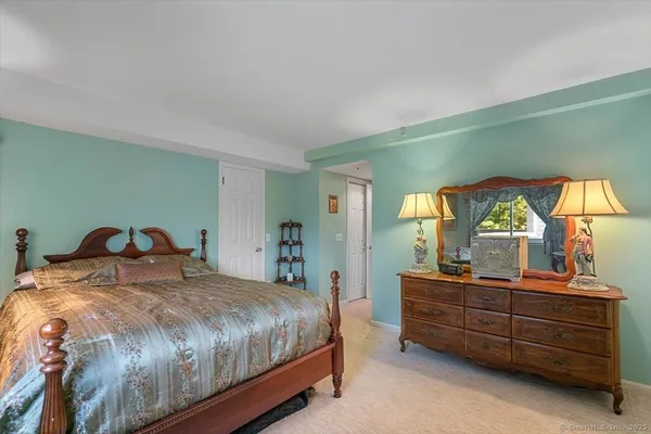 a bedroom with bed and cupboard