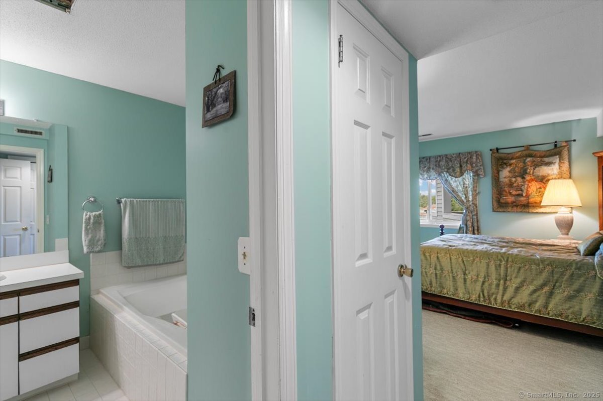 2 Mansfield Grove Road, Unit 262 East Haven, CT 06512 - Photo 24 of 47 The primary bath is located behind the hallway door so you can walk from the primary bedroom to the bath privately.