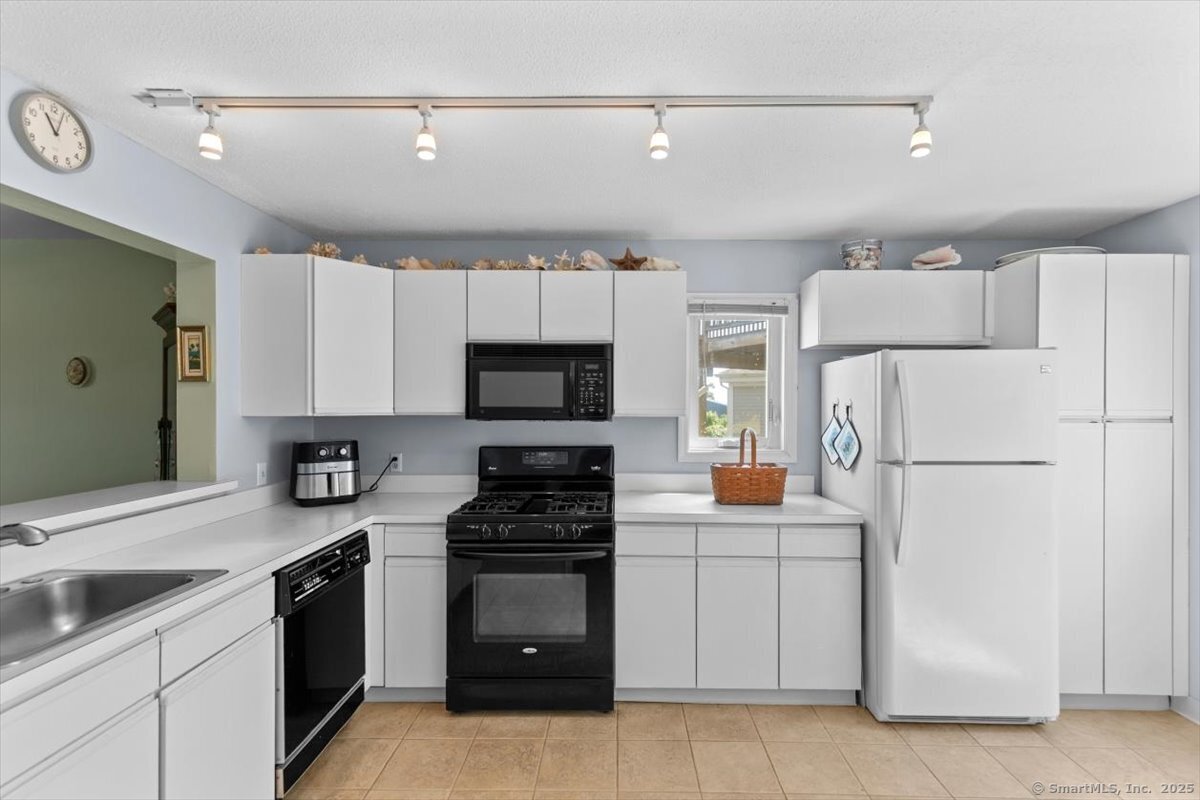 2 Mansfield Grove Road, Unit 262 East Haven, CT 06512 - Photo 3 of 47 The fridge is newer and there are plenty of cabinets for proper kitchen storage.