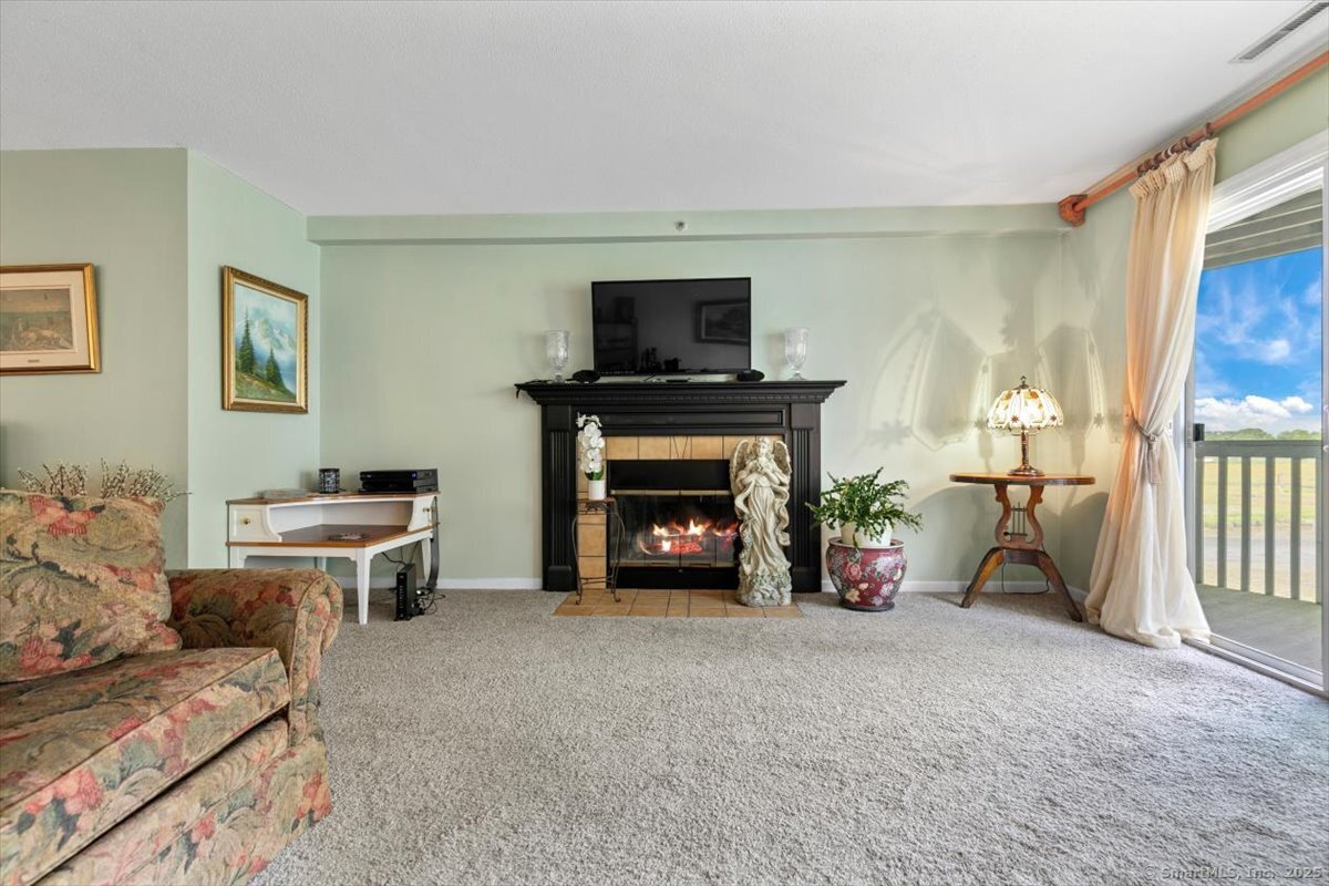 2 Mansfield Grove Road, Unit 262 East Haven, CT 06512 - Photo 8 of 40 The generously sized living room is floored with Berber carpet.