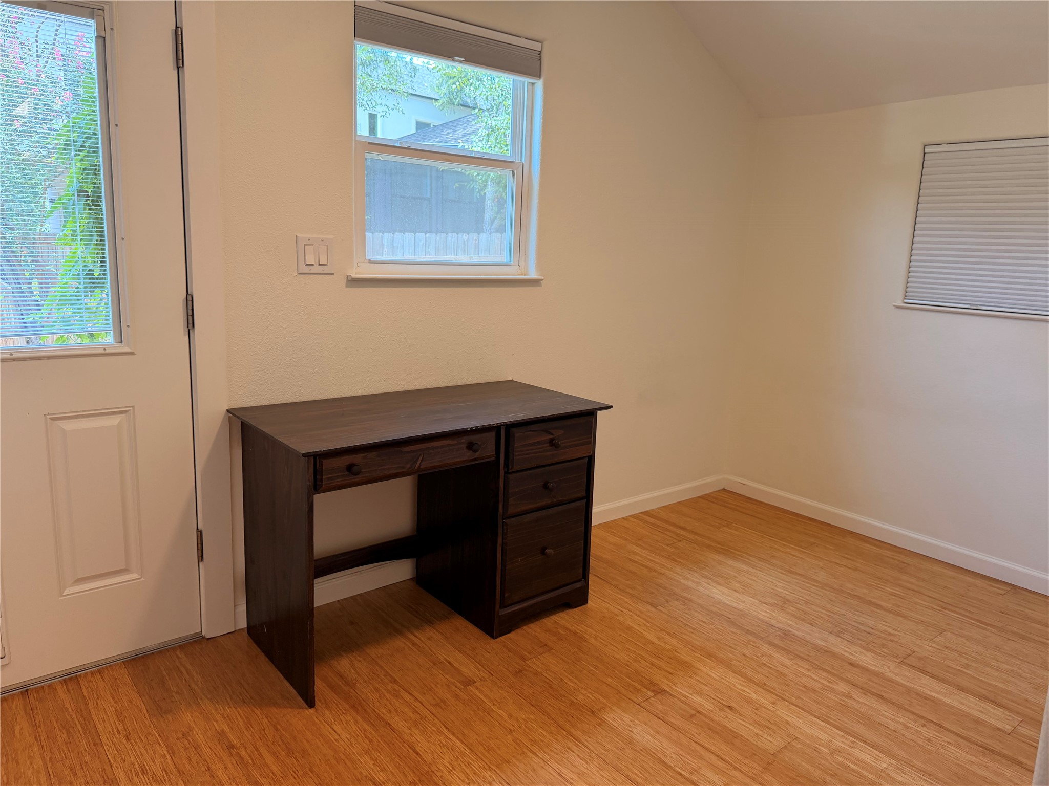 1182 Pandora Street Austin, TX 78702 - Photo 9 of 19 Functional office space featuring durable hardwood flooring and natural light.