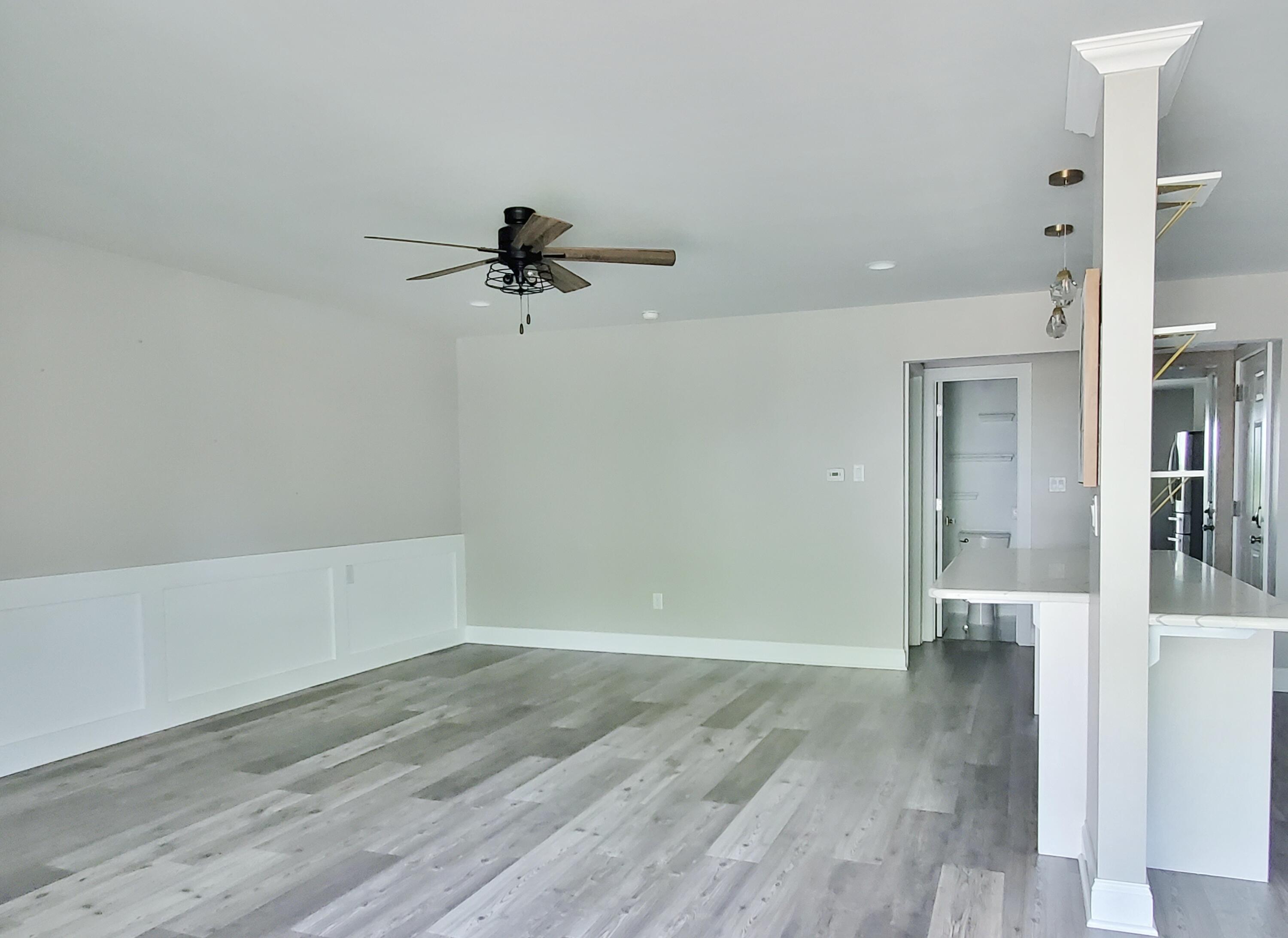 514 Birch Tree Lane Michigan City, IN 46360 - Photo 7 of 23 a view of a room with wooden floor and a ceiling fan