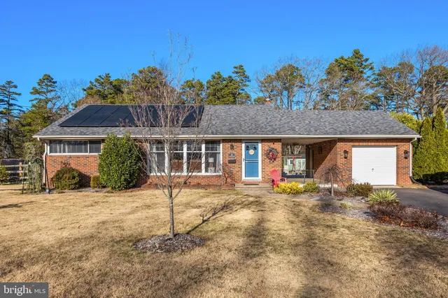 a view of a house with wooden floor and a yard