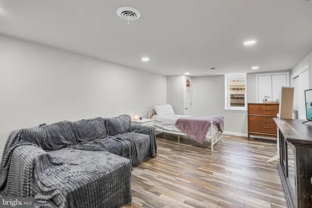 a living room with furniture and a wooden floor