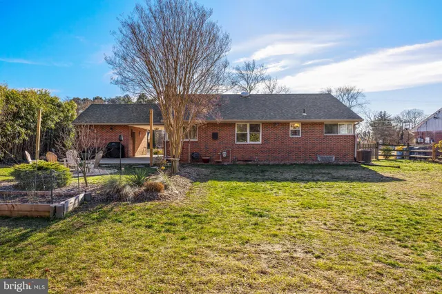 a view of a patio with couches and a table and chairs with wooden fence