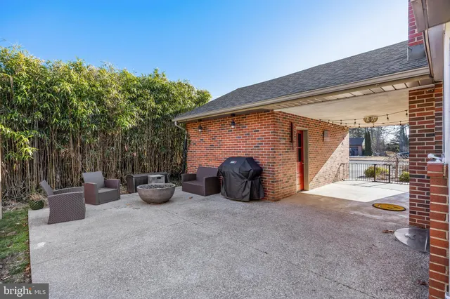 a view of a patio with chairs and potted plants