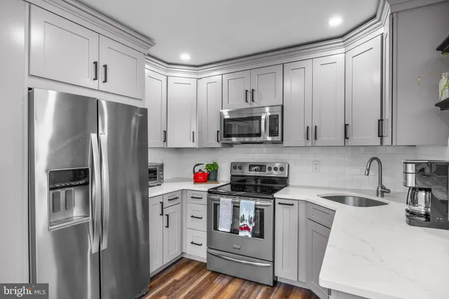 a kitchen with stainless steel appliances a refrigerator stove and sink
