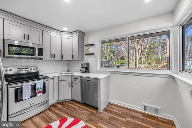 a kitchen with a stove a sink and a microwave