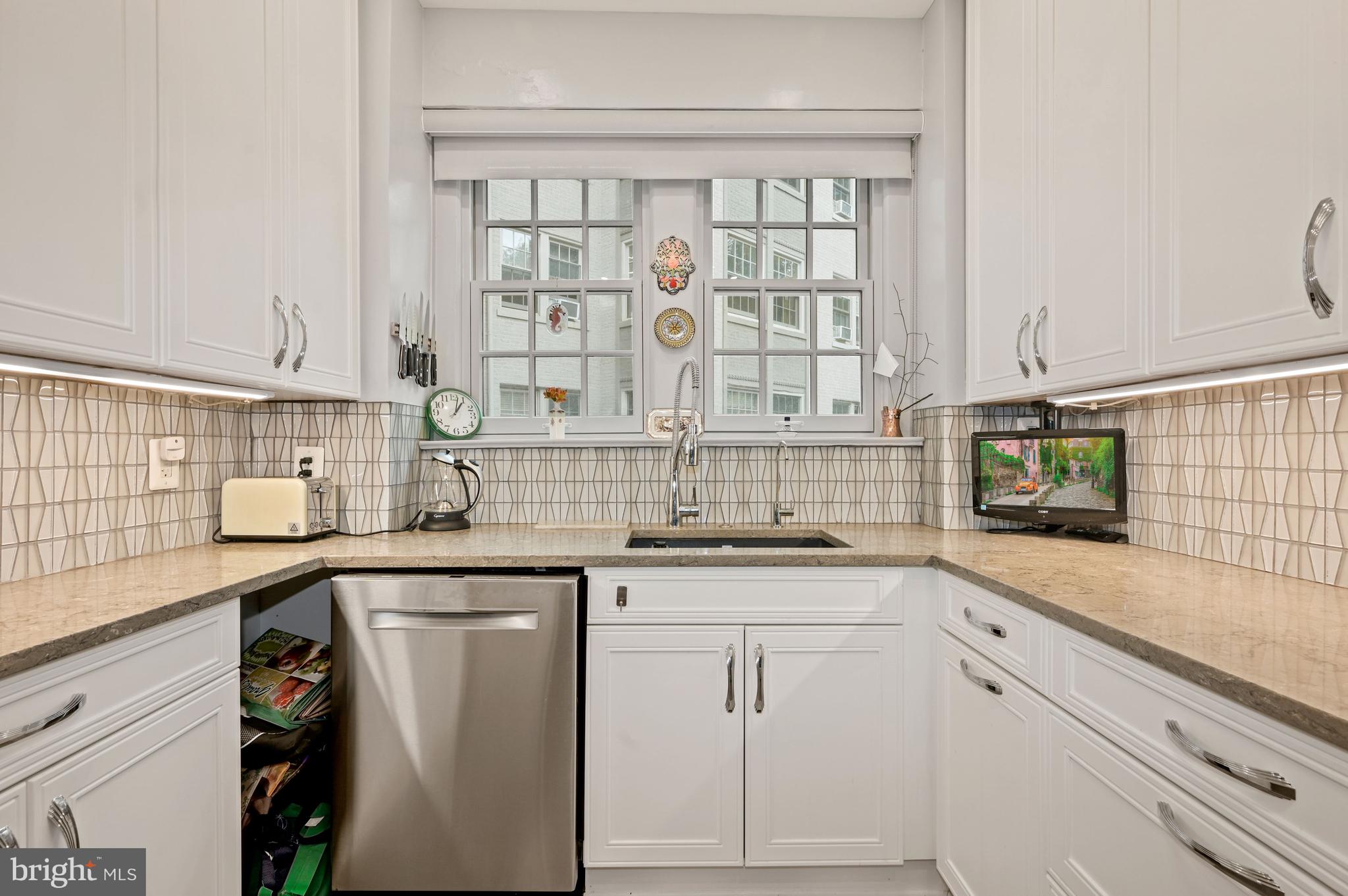 2737 Devonshire Place Northwest, Unit 123 Washington, DC 20008 - Photo 14 of 46 Custom white cabinets, window, gooseneck faucet