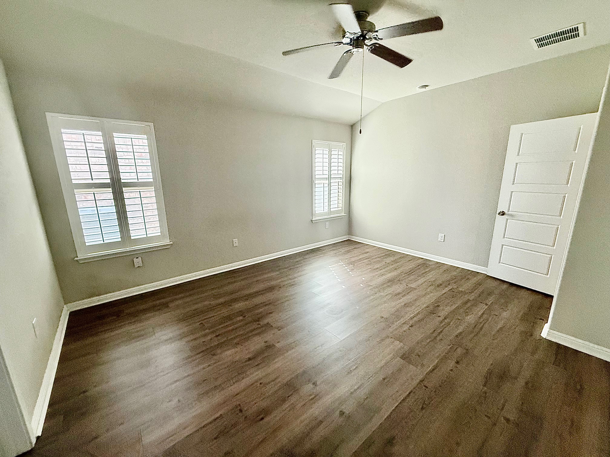 513 Longhorn Cavern Road Leander, TX 78641 - Photo 10 of 24 Empty room featuring a ceiling fan, dark wood-type flooring, and lofted ceiling