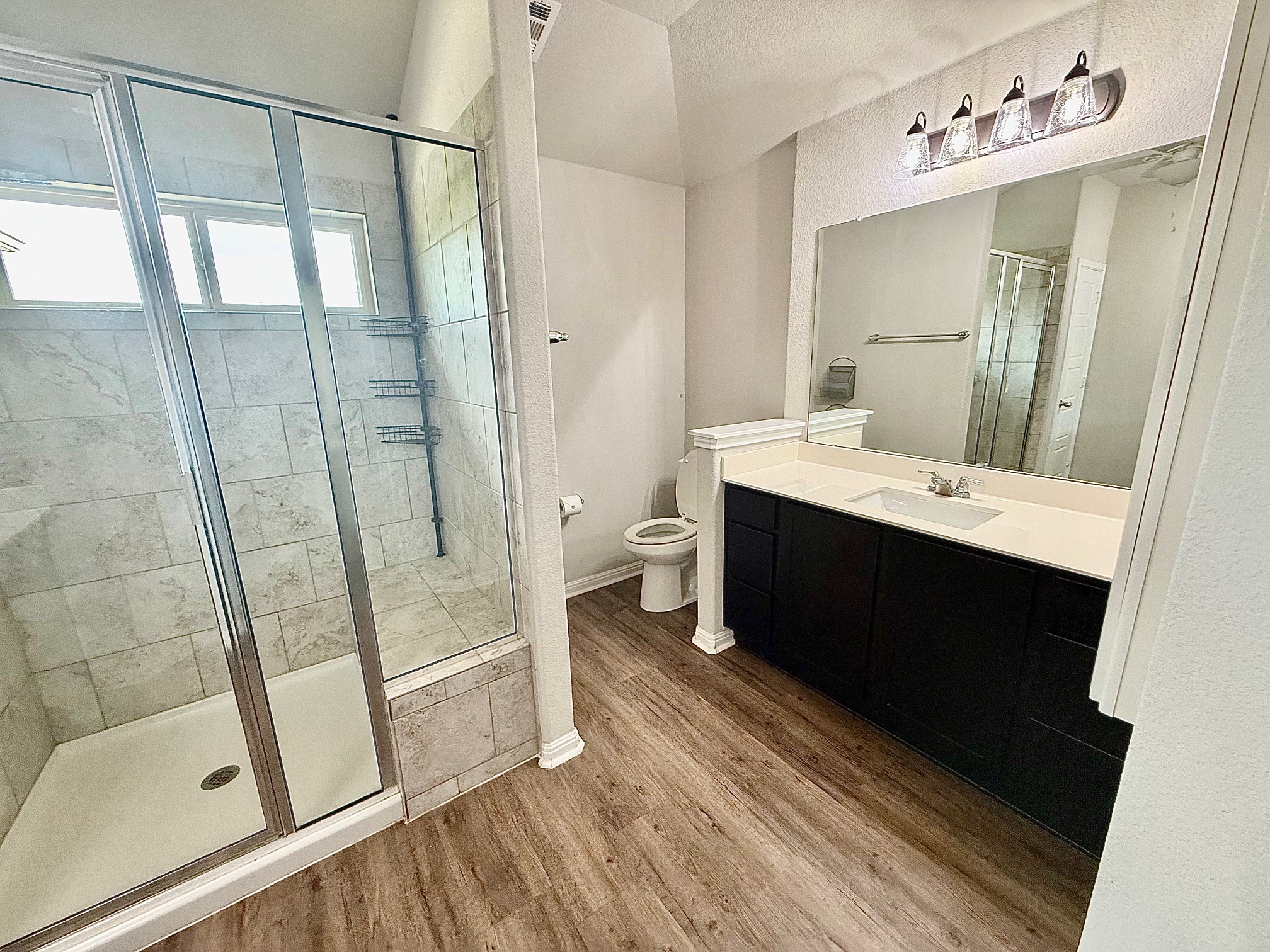 513 Longhorn Cavern Road Leander, TX 78641 - Photo 11 of 24 Full bathroom featuring vanity, a stall shower, and light wood-style flooring
