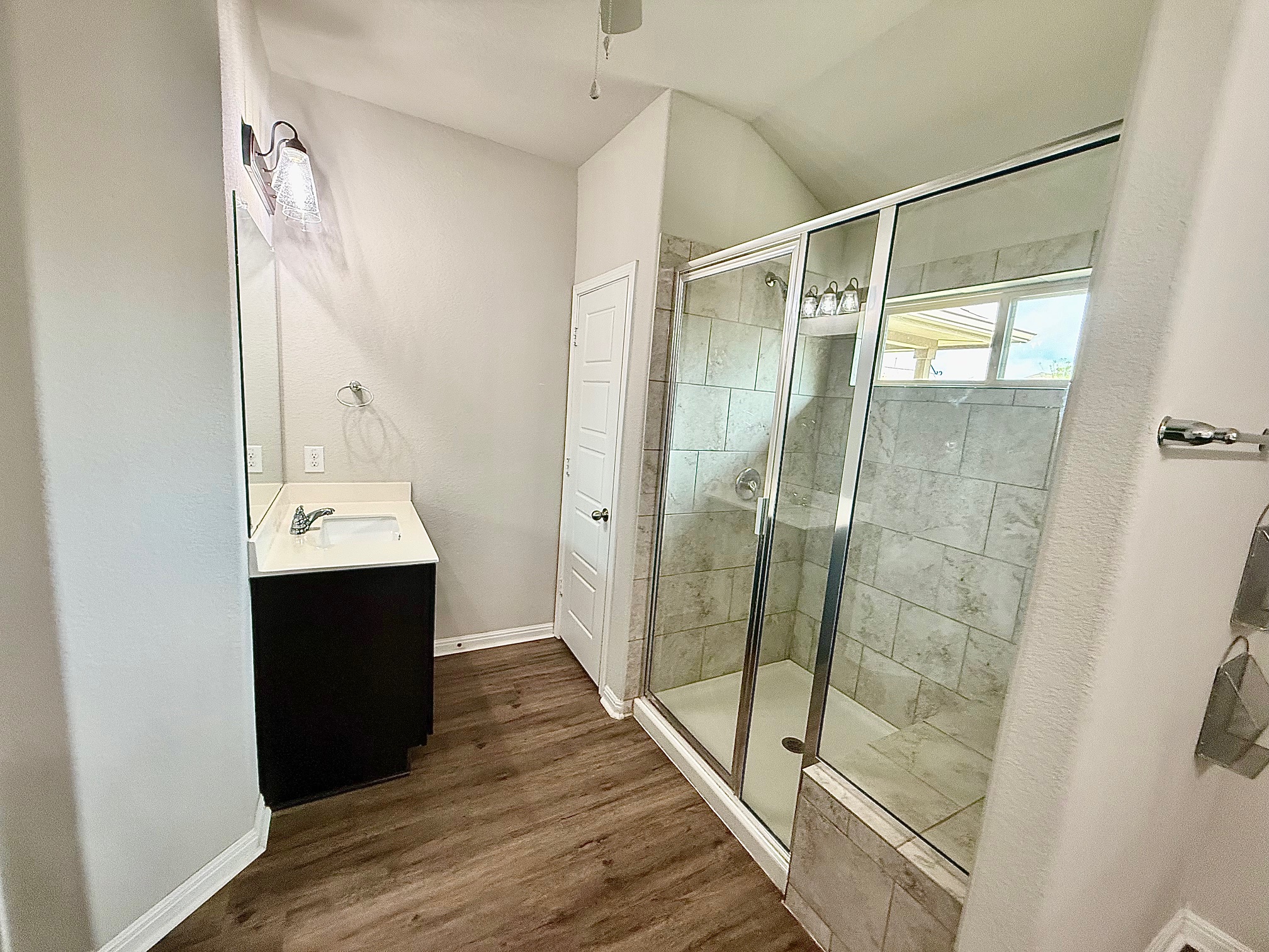 513 Longhorn Cavern Road Leander, TX 78641 - Photo 12 of 24 Bathroom featuring vanity, a stall shower, and dark wood-style flooring