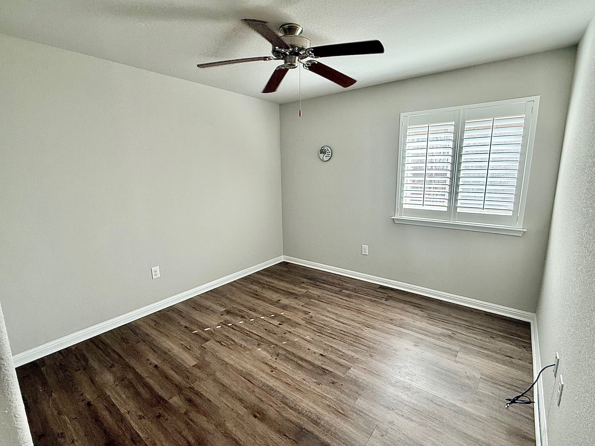 513 Longhorn Cavern Road Leander, TX 78641 - Photo 14 of 24 Empty room featuring a ceiling fan and dark wood finished floors