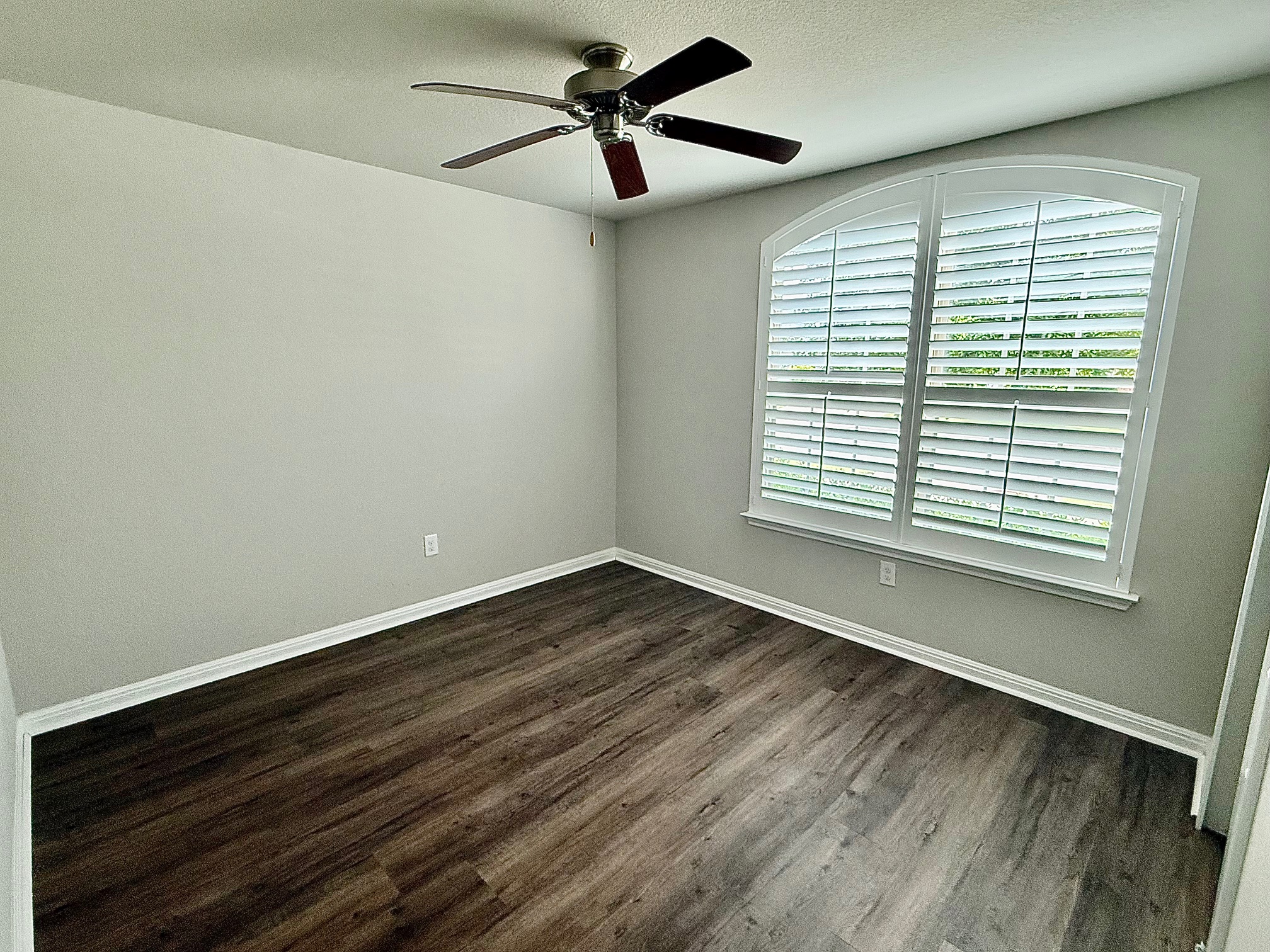 513 Longhorn Cavern Road Leander, TX 78641 - Photo 17 of 24 Empty room featuring a ceiling fan, dark wood-type flooring, and a textured ceiling