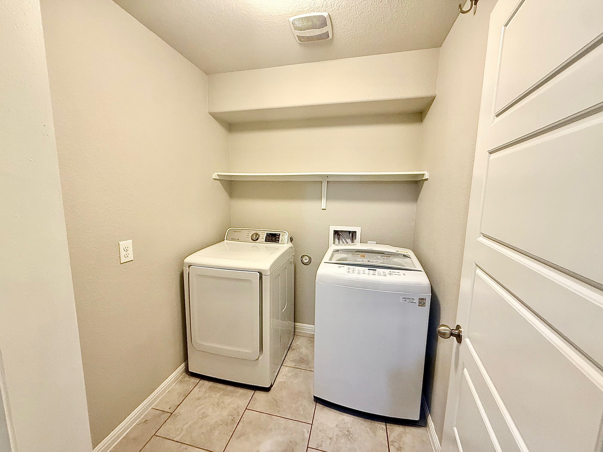 513 Longhorn Cavern Road Leander, TX 78641 - Photo 23 of 24 Laundry area featuring a textured ceiling, separate washer and dryer, and light tile patterned floors