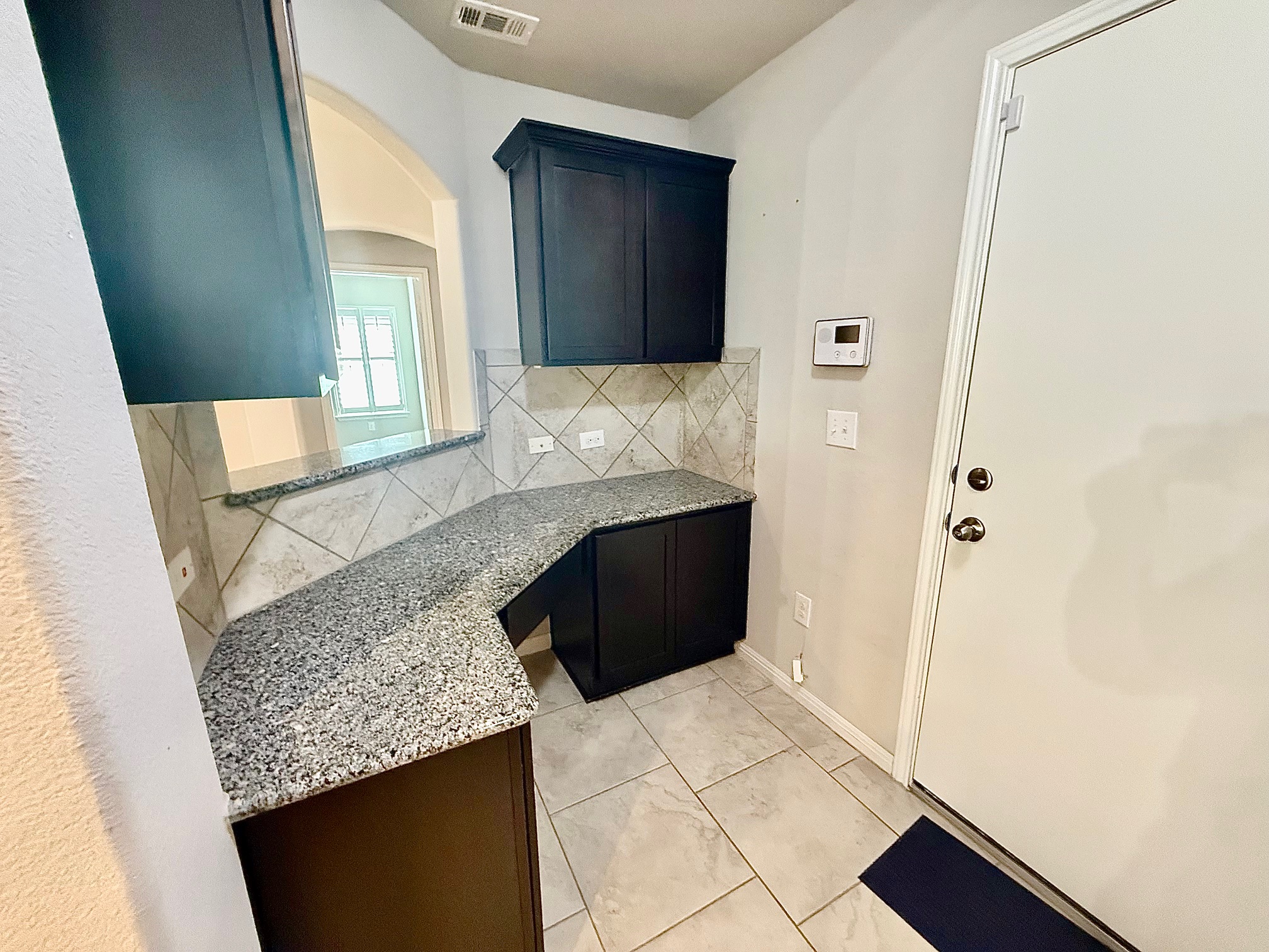 513 Longhorn Cavern Road Leander, TX 78641 - Photo 7 of 24 Work/Study area featuring light stone countertops and decorative backsplash