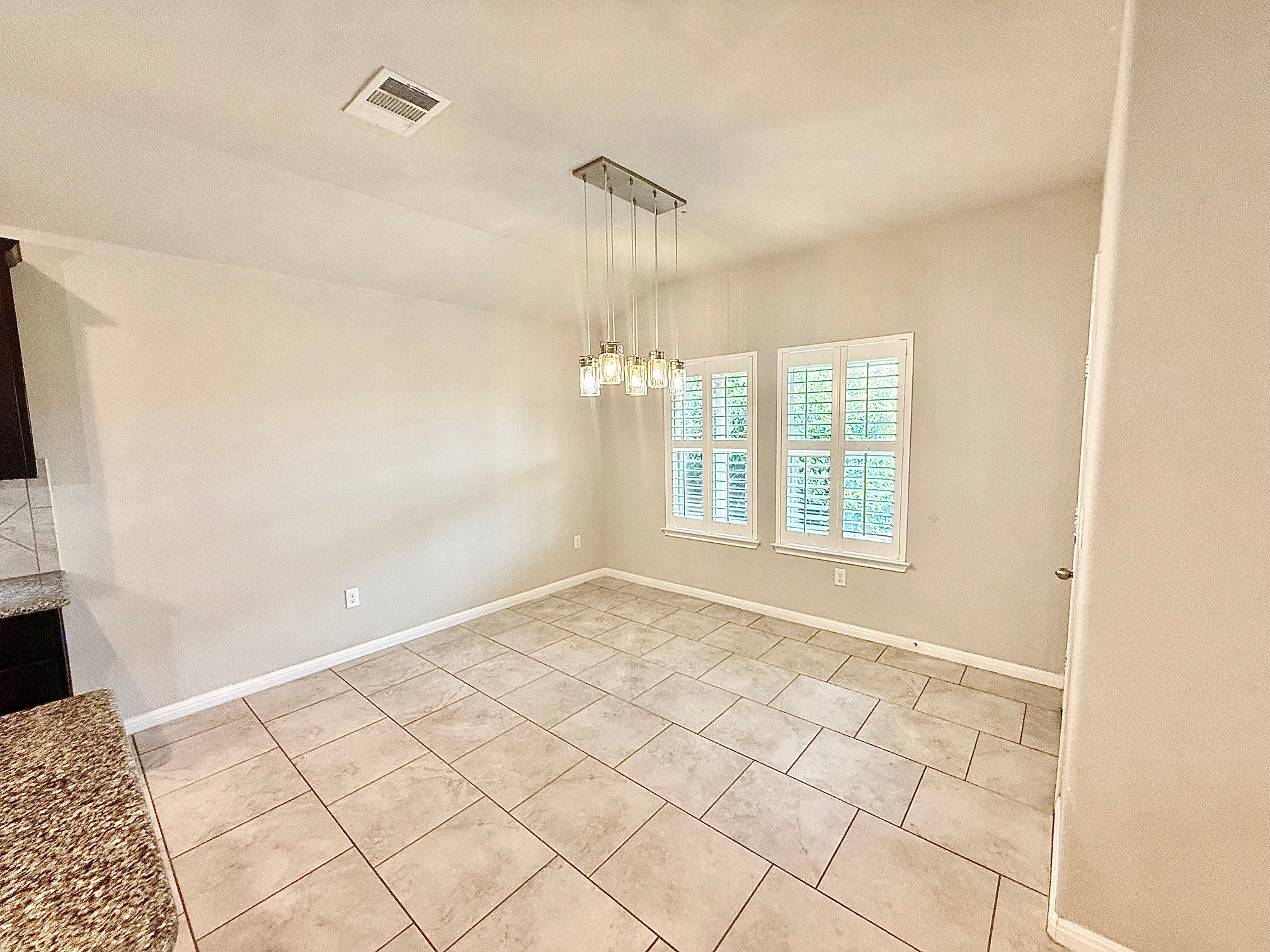 513 Longhorn Cavern Road Leander, TX 78641 - Photo 8 of 24 Unfurnished dining area featuring light tile patterned flooring and hanging lights