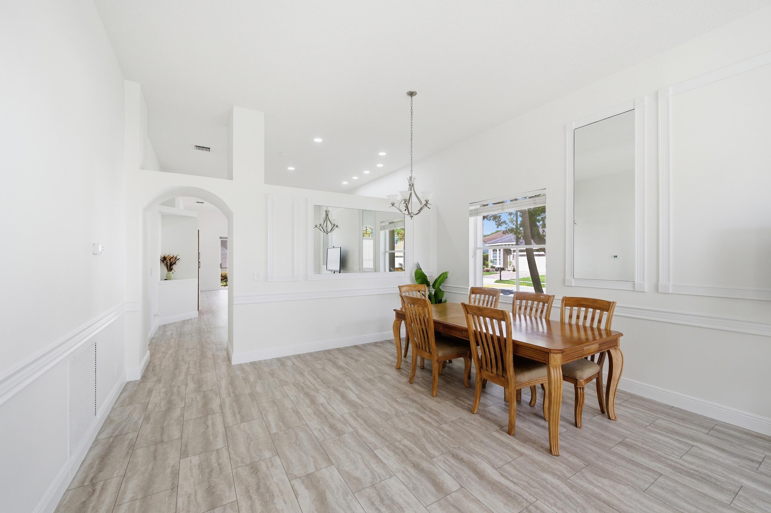 8534 Vía D Oro Boca Raton, FL 33433 - Photo 5 of 34 a view of a dining room with furniture and wooden floor