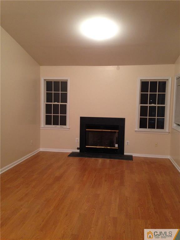1130 Edpas Road, Unit 1130 New Brunswick, NJ 08901 - Photo 3 of 12 an empty room with windows and fireplace
