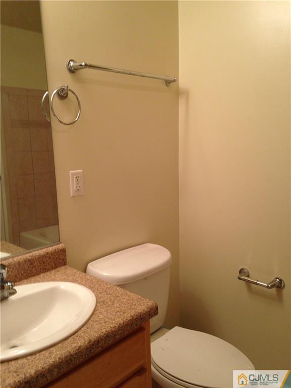 1130 Edpas Road, Unit 1130 New Brunswick, NJ 08901 - Photo 8 of 12 a bathroom with a granite countertop toilet and a sink