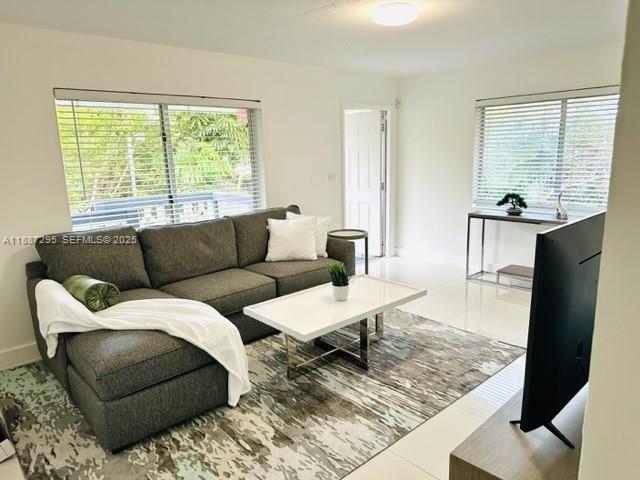 1030 Northeast 80th Street, Unit 4 Miami, FL 33138 - Photo 1 of 28 a living room with furniture and a large window