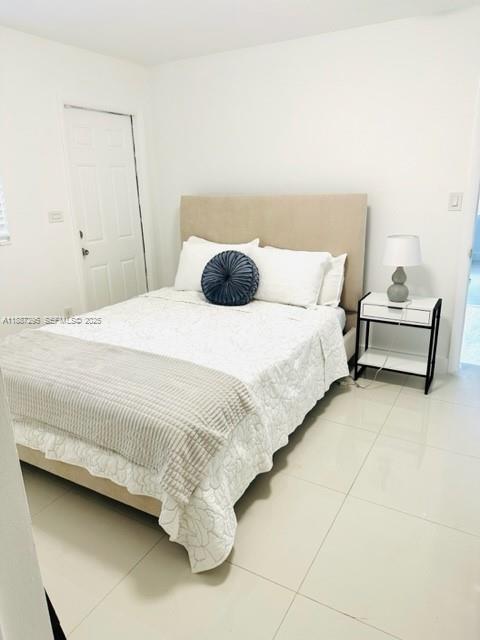 1030 Northeast 80th Street, Unit 4 Miami, FL 33138 - Photo 11 of 28 a bedroom with a bed and a table