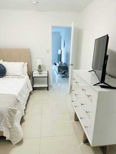 1030 Northeast 80th Street, Unit 4 Miami, FL 33138 - Photo 13 of 28 a bedroom with furniture and a large window