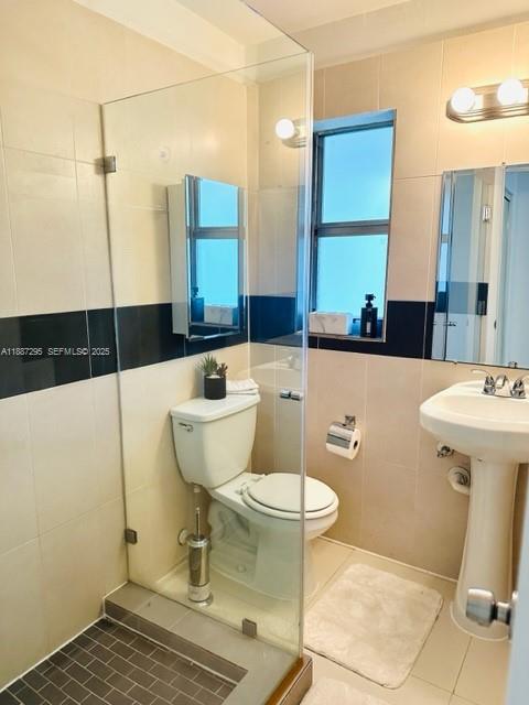 1030 Northeast 80th Street, Unit 4 Miami, FL 33138 - Photo 15 of 28 a bathroom with a sink toilet and shower