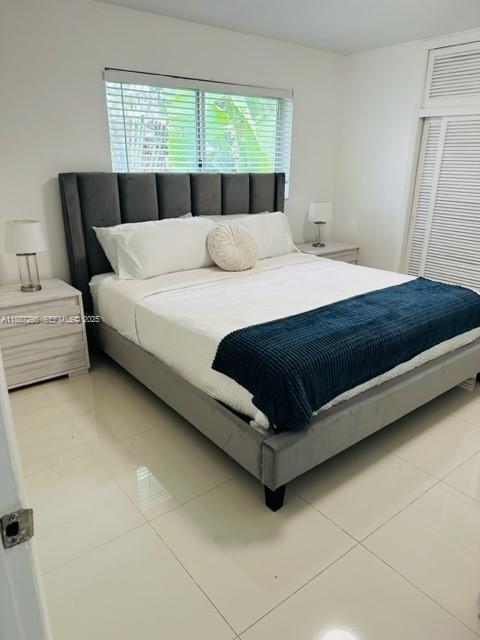 1030 Northeast 80th Street, Unit 4 Miami, FL 33138 - Photo 19 of 28 a bedroom with a bed and window