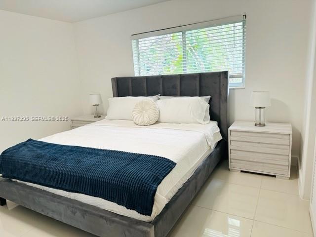 1030 Northeast 80th Street, Unit 4 Miami, FL 33138 - Photo 20 of 28 a large bed sitting in a bedroom next to a window