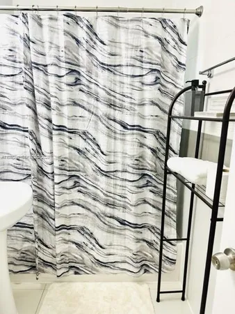a bathroom with a shower curtain and a sink