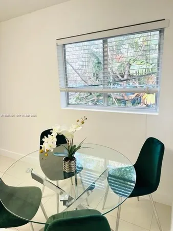 a living room with a table and a chair