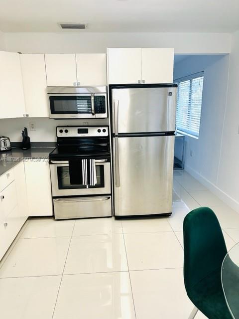1030 Northeast 80th Street, Unit 4 Miami, FL 33138 - Photo 7 of 28 a kitchen with stainless steel appliances granite countertop a refrigerator sink and microwave