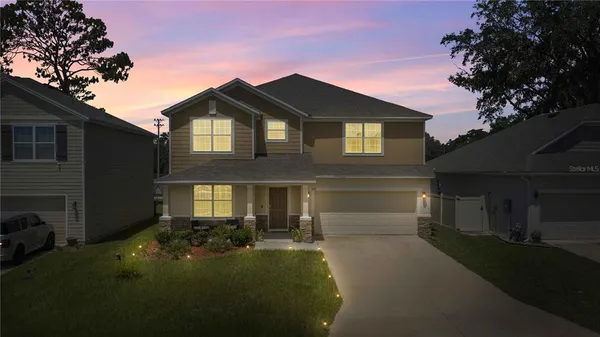 a front view of a house with a yard and garage