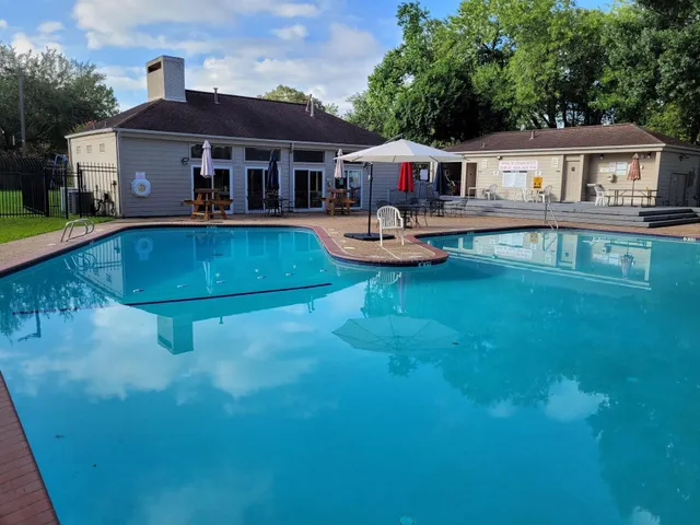 an aerial view of a house with swimming pool yard and patio