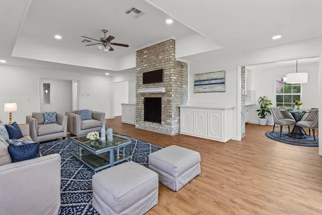 a living room with furniture fireplace and wooden floor