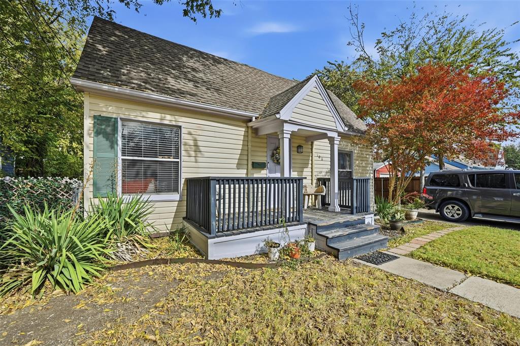 a view of a house with a small yard and wooden fence